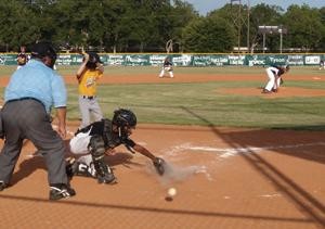 The catcher on the Refugio Little League baseball team barely misses catching a ball pitched to a Shiner batter last Thursday night at Independence Park in Gonzales. Refugio won the game, 16-6.  Photo by Nikki Maxwell