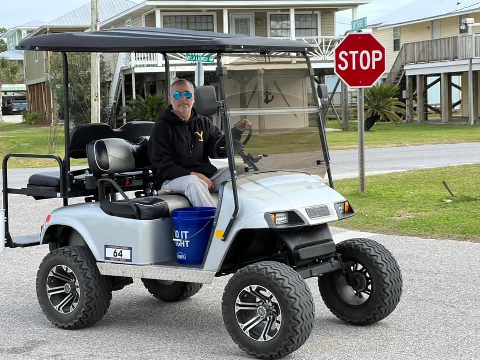 Orange Beach golf cart permit numbers are displayed on both sides of the cart for ease of identification.