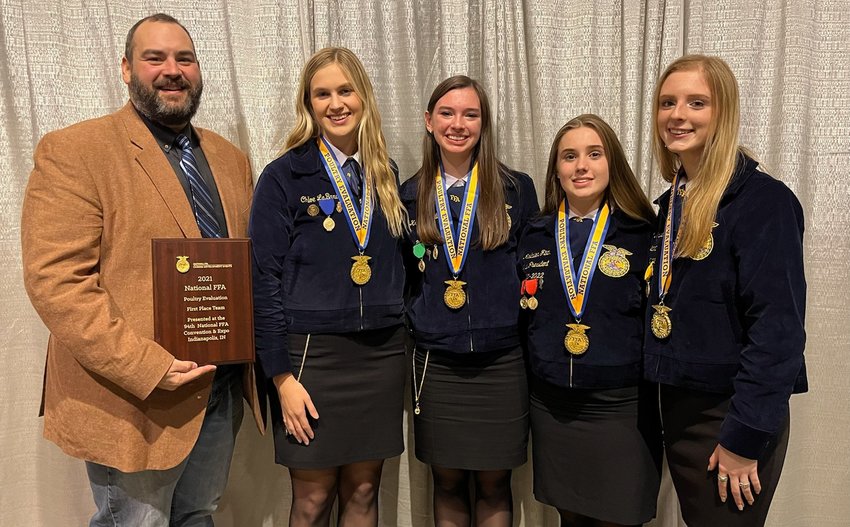 Taylor High School agricultural sciences teacher and Future Farmers of America coach David Laird (left) holds the plaque naming Taylor FFA as the national champions in poultry evaluation for 2021. He is accompanied by Taylor FFA poultry team members (from left to right) Chloe LaBard, Kristen Justilian, Madailein Fitch and Taylor FFA president Kathryn &ldquo;Kacki&rdquo; Kyrisch who each placed in the top five of individual events in addition to winning the overall team championship.