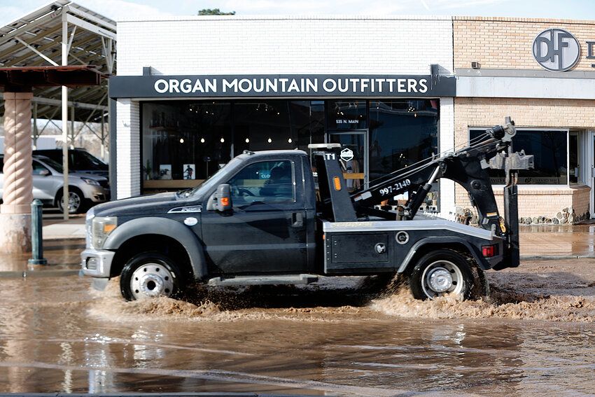 A tow truck drives through flooding on N. Main Street downtown Las Cruces on Friday, Jan. 12.