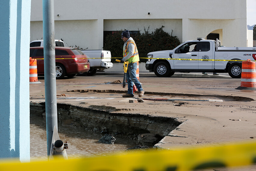A city utility worker on scene near American Linen and Uniform Supply in downtown Las Cruces, at N. Main Street and Hadley Avenue, after a broken hydrant caused flooding and damage to the business location on Friday, Jan. 12.