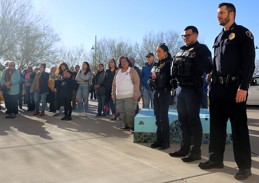 LCPD Chief Jeremy Story, right, stands beside a hundred-person crowd at City Hall on Jan. 14. Story marched alongside the crowd and gave a speech before the march.