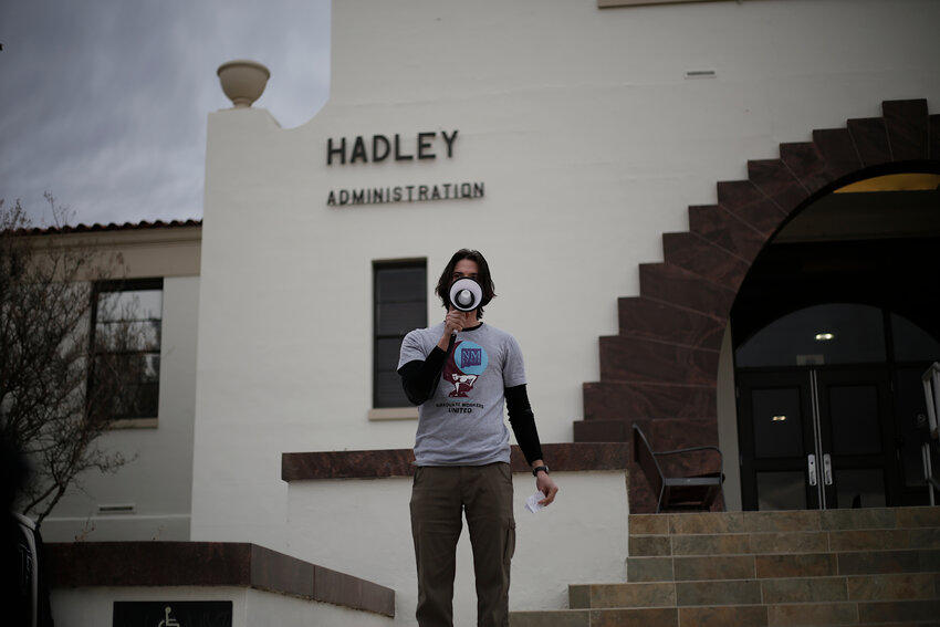 Alexander Allison, biology research assistant, takes the megaphone during a rally in front of Hadley Hall at New Mexico State University on Feb. 6, 2024.