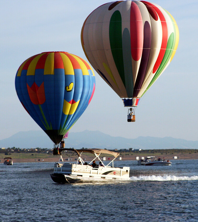 Chase boats follow and meet each balloon at the Elephant Butte Balloon Regatta at Elephant Butte Lake State Park.