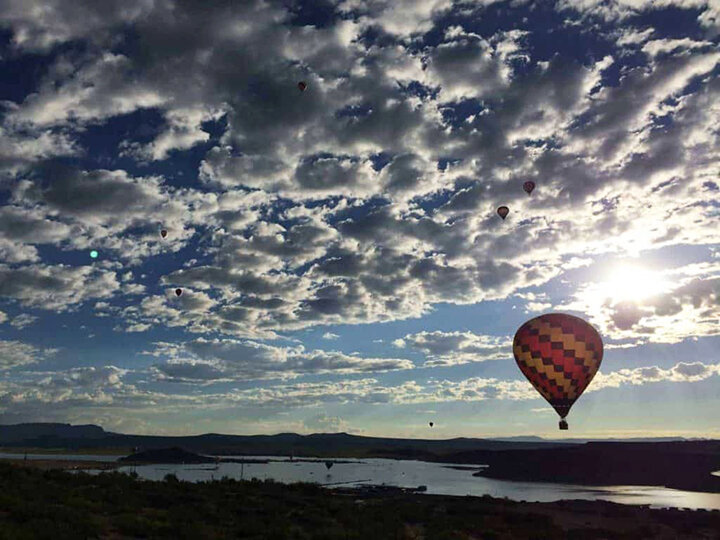 Balloons dot the sky for spectacular views at the Elephant Butte Balloon Regatta over Elephant Butte Lake State Park.