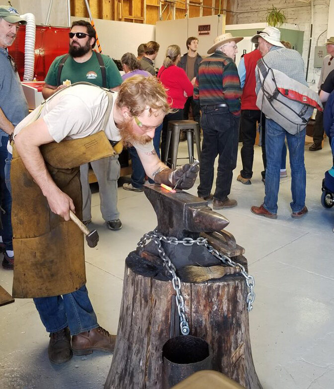 Nick Barton demonstrates blacksmithing at a Future Forge open house in 2020.
