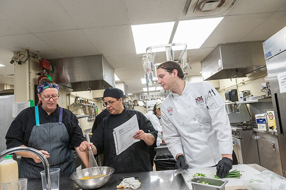 Chef Danielle Young (left) instructs students at Westside Bistro at Gerald Thomas Hall.