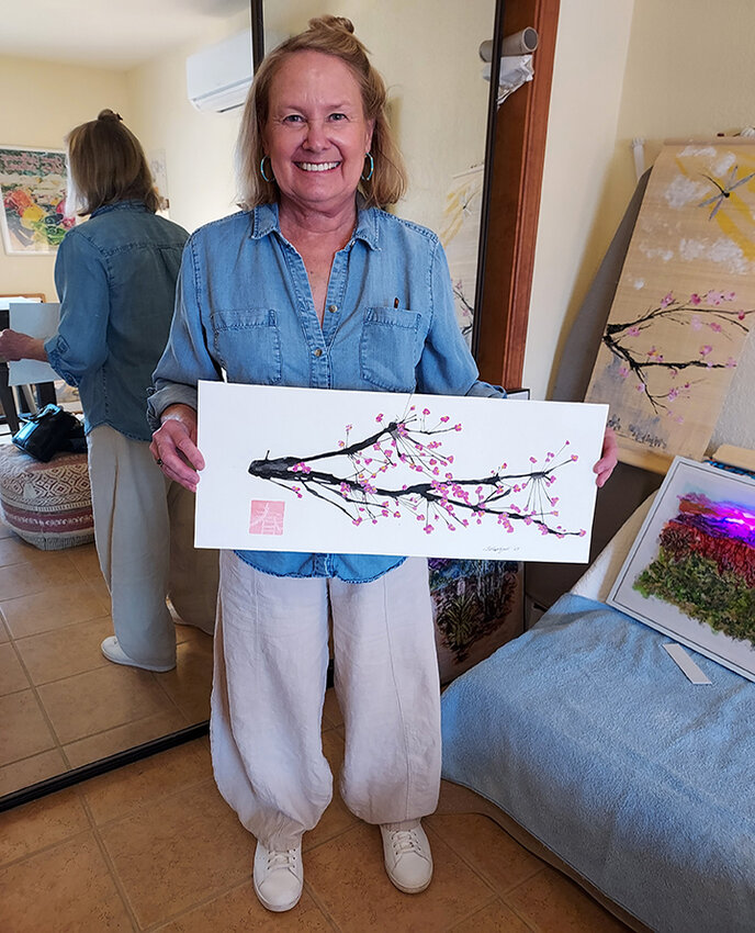 Student Sally Lightfoot displays the work she created in Lucy Reser’s workshop