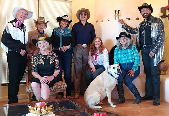 Left to right are NMSU Theatre Department Head Wil Kilroy, ASTC Board members Barb Ross and Carolyn Williams (seated), Boots and Bling volunteers Bonnie Hacke and Ken and Pam Lucas, ASTC Board President Denise Welsh and Boots and Bling silent auction donor Sergio Chavez. Molly the dog belongs to Bonnie Hacke. Photo by Mike Cook.