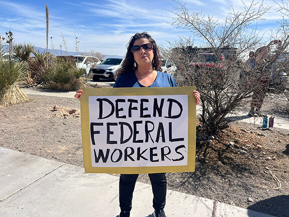 Denise Ottaviano of Tularosa, New Mexico, displays her sign as she demonstrates during an event March 1, 2025, at White Sands National Park in support of federal workers.
