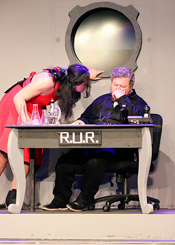 The robot leader Radius (Niko Gonzales) confronts Mr. Alquist (David Martin) about robot regeneration in LCCT’s production of Rossum’s Universal Robots.