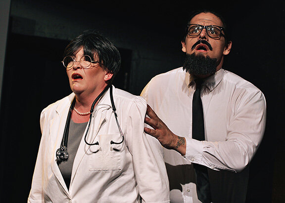 Doctors Gall (Joy Lightfoot) and Hallemeier (Chad Gonzalez) react to the invasion of the robots in LCCT’s production of Rossum’s Universal Robots.