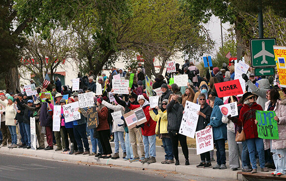 A crowd of people carrying signs lined Main Street and gathered at Albert Johnson Park at the Hands Off! Protest on April 5, 2025. The nationwide protest to oppose President Trump’s recent executive orders and policy changes implemented by the Department of Government Efficiency.