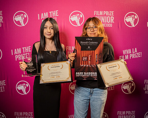 Deming Middle School winner Hannah Gutierrez and her cousin, holding awards for Audience Choice and Best Movie Poster for “Coulrophobia.”