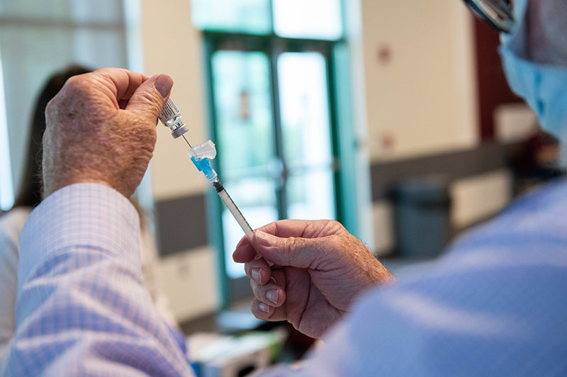 John Landrum, NMSU's Pharmacist prepares a Johnson and Johnson Covid-19 Vaccination during a walking in clinic at Corbett Center. May 13, 2021. (NMSU Photo by Josh Bachman)