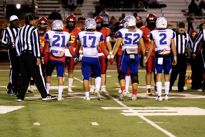 Togetherness and building a family atmosphere have been keys to the success of Las Cruces High football over the years and this year was no exception. Here Bulldawq players hold hands before the kickoff of their rematch with Centennial during the second round of the state 6A playoffs