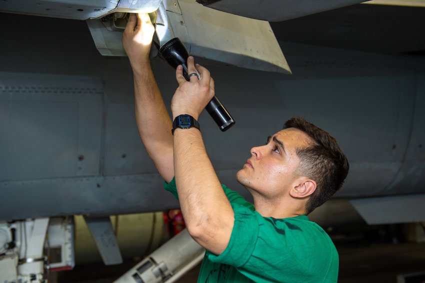 211204-N-TL932-1008 PHILIPPINE SEA (Dec. 4, 2021) Aviation Structural Mechanic 3rd Class Marcus Herrera, a native of Las Cruces, N.M., conducts maintenance on an EA-18G Growler assigned to the &ldquo;Gauntlets&rdquo; of Electronic Attack Squadron (VAQ) 136, in the hanger bay aboard Nimitz-class aircraft carrier USS Carl Vinson (CVN 70), Dec. 4, 2021. Carl Vinson Carrier Strike Group is on a scheduled deployment in the U.S. 7th Fleet area of operations to enhance interoperability through alliances and partnerships while serving as a ready-response force in support of a free and open Indo-Pacific region. (U.S. Navy photo by Mass Communication Specialist Seaman Apprentice Joshua Sapien)