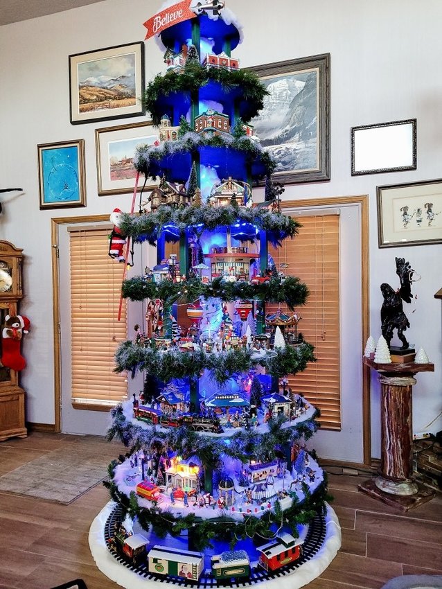 Samuel McGillivray, a senior at Mesilla Valley Christian School, helped a Las Cruces neighbor, Karen, put up this tree in her home. Karen recently lost her husband, and Sam wanted to help her keep their tradition of putting up a special tree at Christmas going. Using more than 600 pieces that had been part of a Christmas village, it took them more than two weeks of work to decorate the 15-foot tree, Sam said. Karen&rsquo;s husband had worked for the railroad and was a car enthusiast, &ldquo;so we added a train station along with a train that goes around the bottom,&rdquo; Sam said. A Hallmark pedal car collection was also added, along with a plane that flies around the top of the tree to honor Karen&rsquo;s father, who was in the U.S. Air Force.