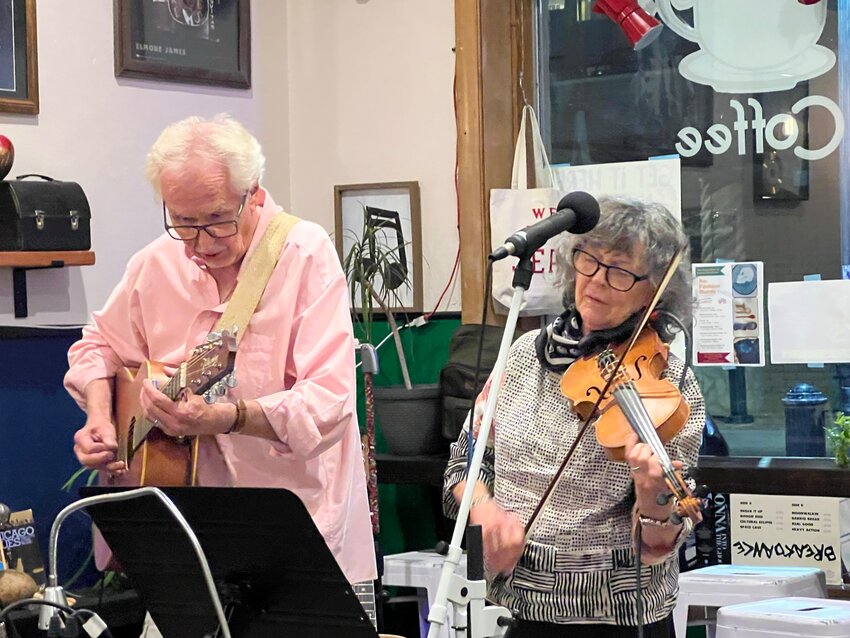 Cleve, left, and Mary, far right, jam with some friends recently at Downtown Blues Coffee, where on Sept. 8 Cleve will read from and sign copies of his book, 