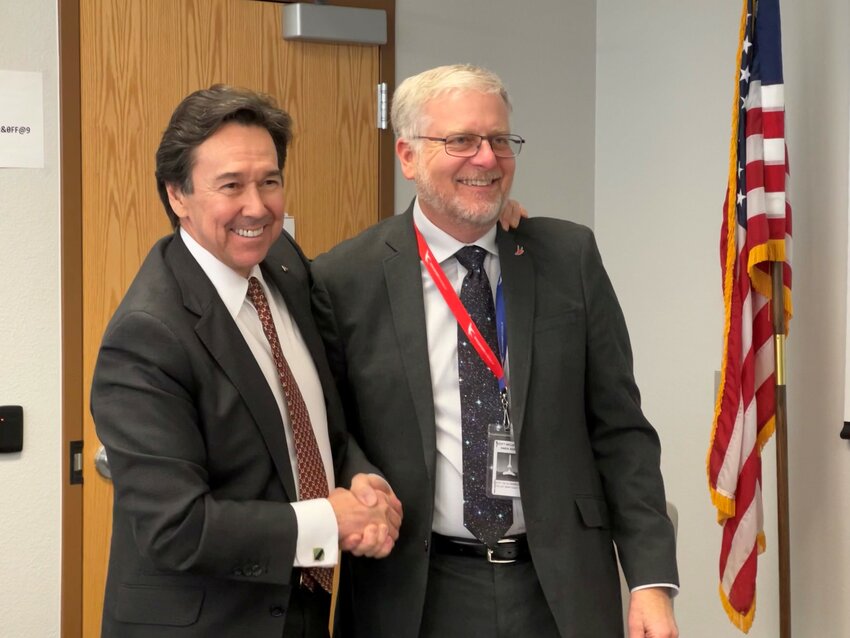 Borderplex Alliance CEO Jon Barela and Spaceport America director Scott McLaughlin shakes hands after signing a memorandum of understanding at the spaceport&rsquo;s business headquarters in Las Cruces on Jan. 4