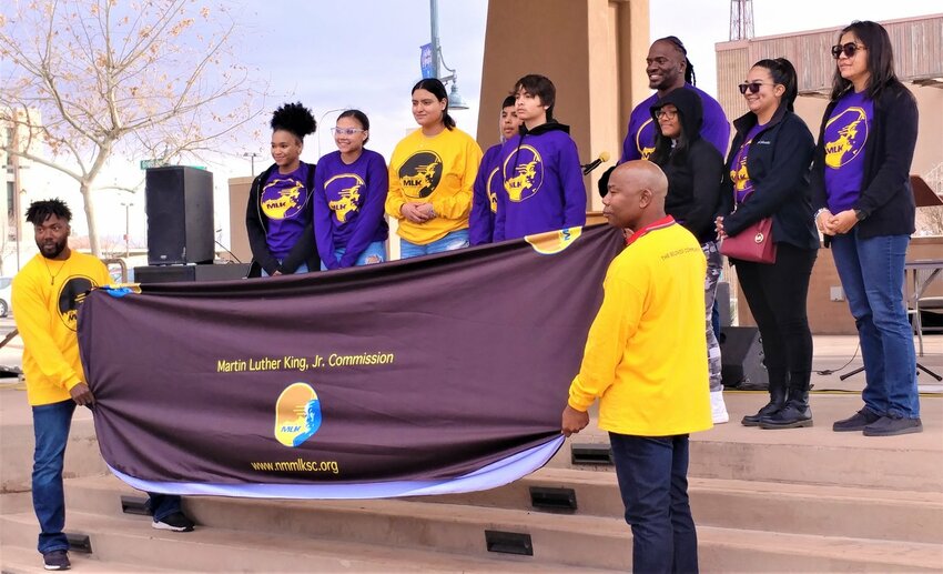 Members of the Martin Luther King Jr. Commission, with Do&ntilde;a Ana County Sheriff&rsquo;s Office Sgt. Jamar Cotton in the background, participate in the 2023 rally commemorating Martin Luther King Jr. in Las Cruces.