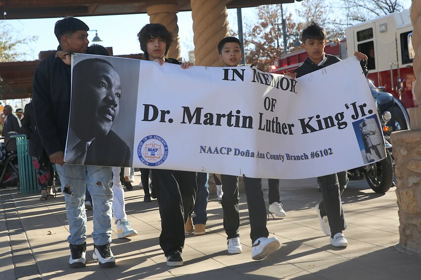Four Martin Luther King Jr. Leadership Program members lead a march through downtown Las Cruces on Jan. 14.