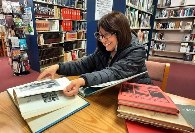 Magdalena Hinckley, a Utah resident spending the winter in southern New Mexico, visits the Hatch Public Library on Thursday, Jan. 25, 2024, to review yearbooks from the late 1960s. She attended Hatch schools through the seventh grade and says she&rsquo;s glad the library had the books on hand.