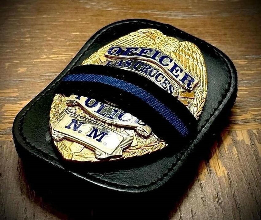 A Las Cruces Police Department service badge is shown with a blue-mourning band commemorating the Feb. 11 death of Officer Jonah Hernandez in the line of duty.