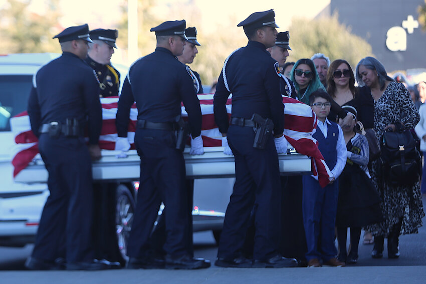 Las Cruces police officers carry Jonah Hernandez's body on Feb. 21. 2024, as his family watches during funeral services in El Paso, Texas.
