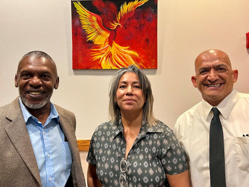 Michael Hubbard, left, a new graduate of the Do&ntilde;a Ana County Veterans&rsquo; Treatment Court program, stands with fellow graduates Magdalena Escoto and Frank Lopez in front of Escoto&rsquo;s painting of a phoenix rising from flames at the 3rd Judicial District courthouse in Las Cruces, Feb. 19, 2024.
