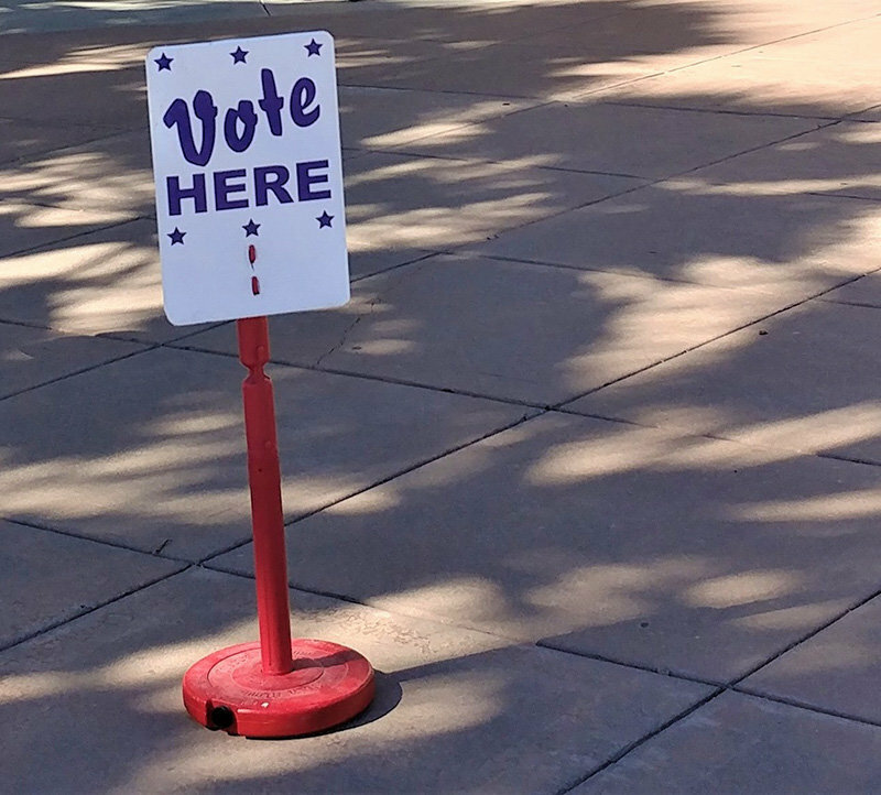 A voting sign stands outside the Doña Ana County Government Center in Las Cruces.