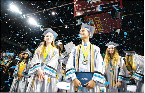 High school students celebrate graduation in a large ceremony at New Mexico State University’s Pan-Am Center in 2016.