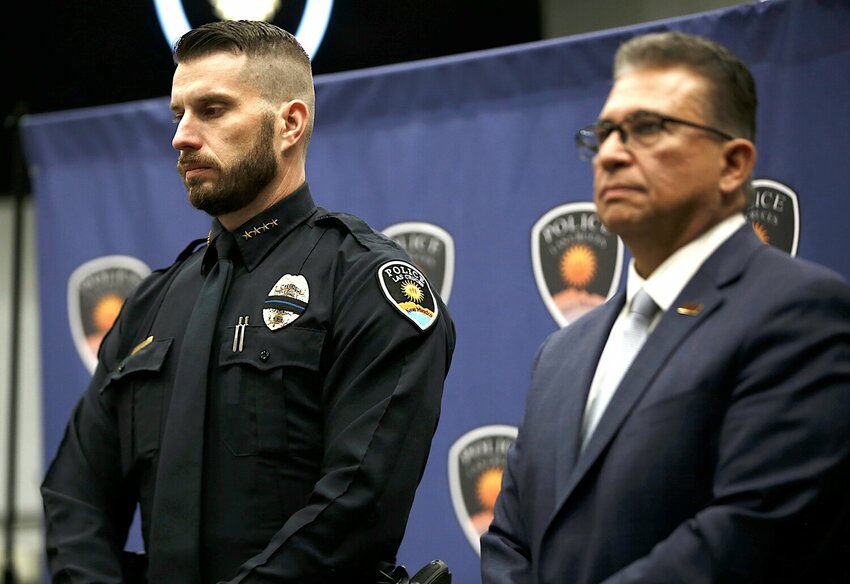 Las Cruces police chief Jeremy Story stands next to Mayor Eric Enriquez during a news conference on Feb. 13