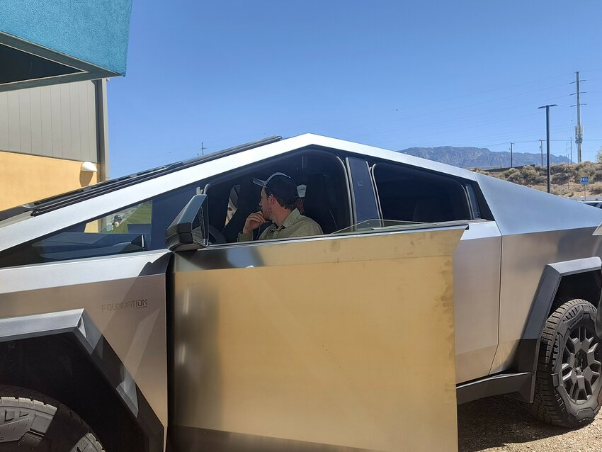 Dylan Connelly with Affordable Solar sits inside a Tesla Cybertruck that his company owns during the Electrify New Mexico Conference on April 4, 2024, in Albuquerque (Photo by Hannah Grover/NM Political Report)