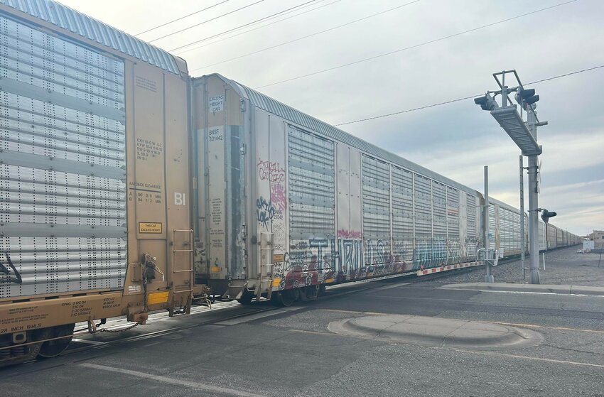 A stalled southbound BNSF train blocks a railroad crossing in Las Cruces on Wednesday, April 24, 2024.