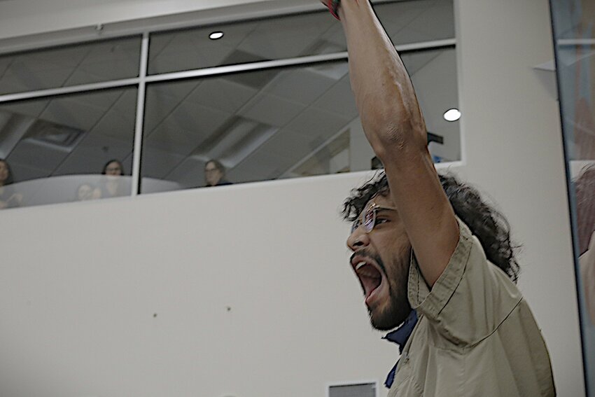 Jovany Hernandez yells, &quot;Viva Palestina!&quot; as Las Cruces city workers watch from above at city hall on May 6, 2024.