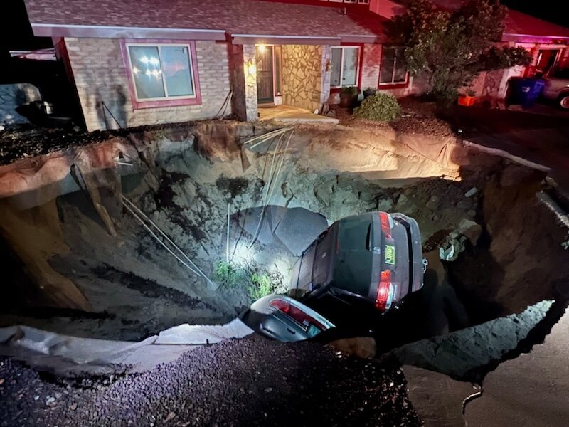 A sinkhole on the 1700 block of Regal Ridge Street in Las Cruces swallowed two vehicles and forced the temporary evacuation of three homes on May 6.