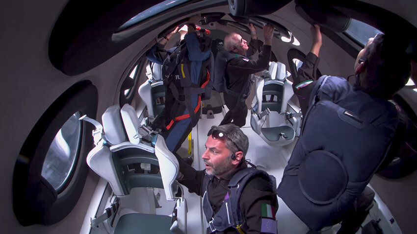 View inside VSS Unity as those on board look out the windows in astonishment as they float around the cabin.