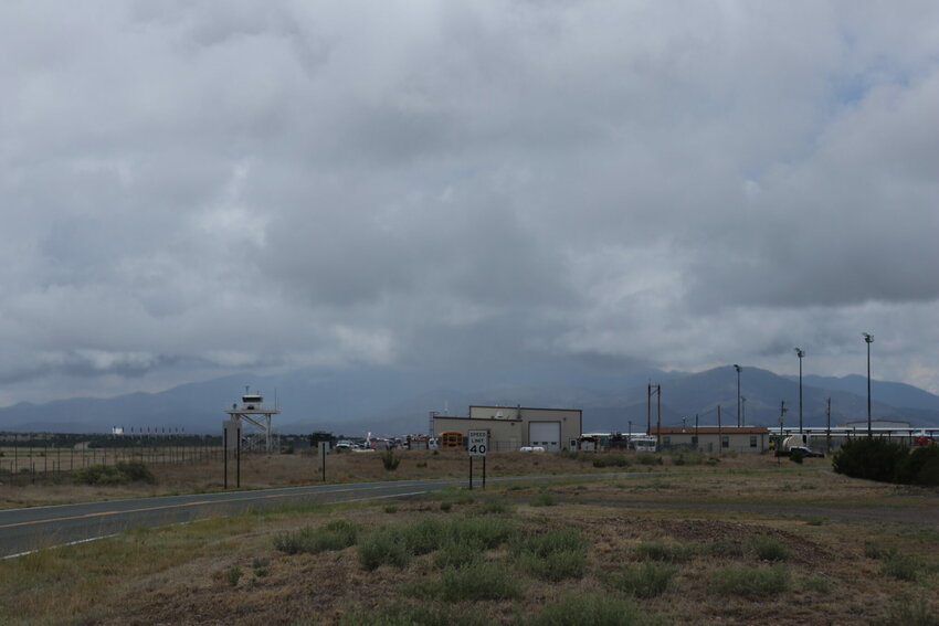 The plume of the South Fork fire seen behind the Sierra Blanca airport mixes with the storm clouds overhanging the Sacramento Mountains Thursday, June 20, 2024.