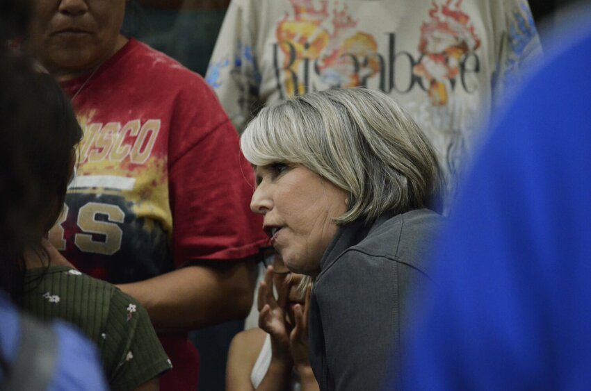 Gov. Michelle Lujan Grisham speaks with a child evacuated from the South Fork and Salt fires at a shelter at the New Mexico Military Institute on June 19, 2024.