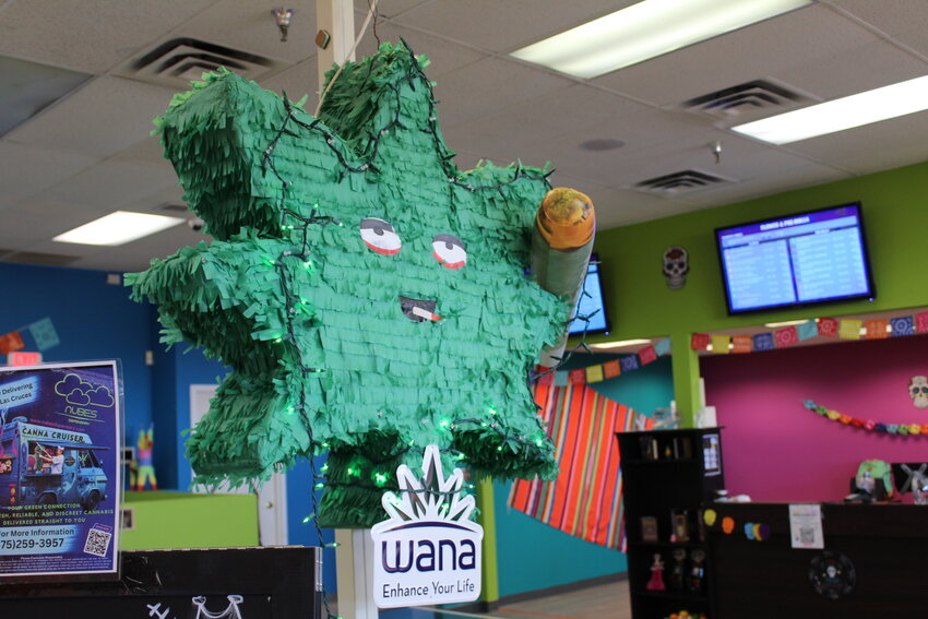 A piñata in the shape of a cannabis leaf is part of the decor in the showroom of Nubes Dispensary in Las Cruces, on Sept. 19, 2024.