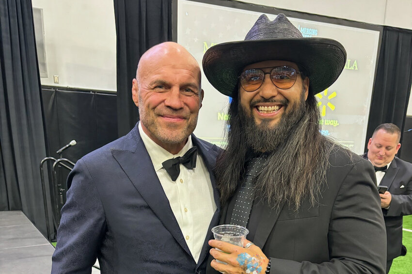 Artist Abel Garcia, right, with UFC (Ultimate Fighting Championship) three-time heavyweight champion Randy Couture at an event during which Garcia painted for a Dallas Cowboys’ event bringing veterans and players together.