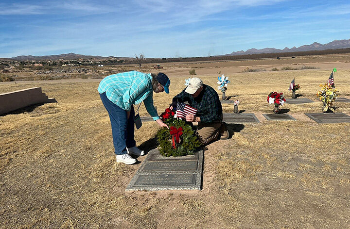 Veteran Fred Huff, right, and his wife Lynda arrange a wreath on the grave of his friend, U.S. Army veteran Carl Bernard Rawson, on Wreaths Across America Day at HillCrest Cemetery in Las Cruces in 2023.