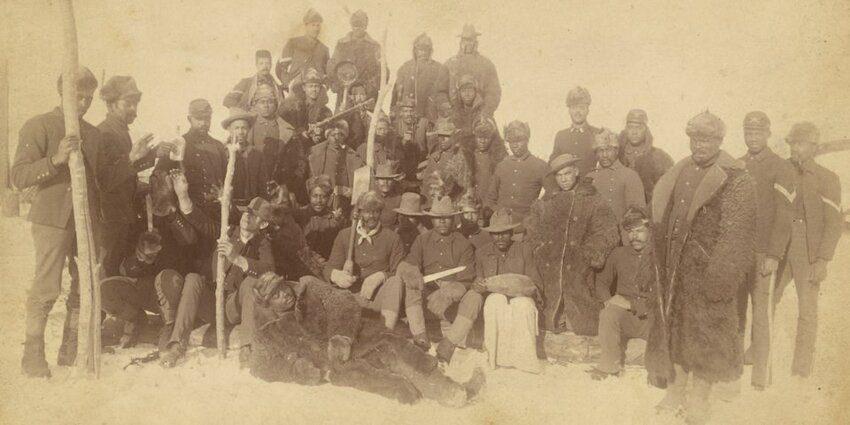 Buffalo Soldiers at Fort Keogh, Montana, in 1890 wear their heavy coats against the chill of winter.