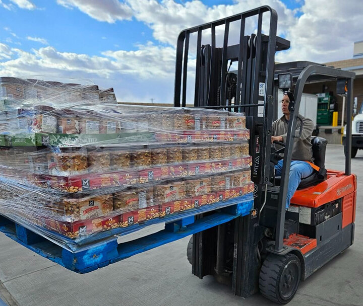 A worker distributes peanut butter.
