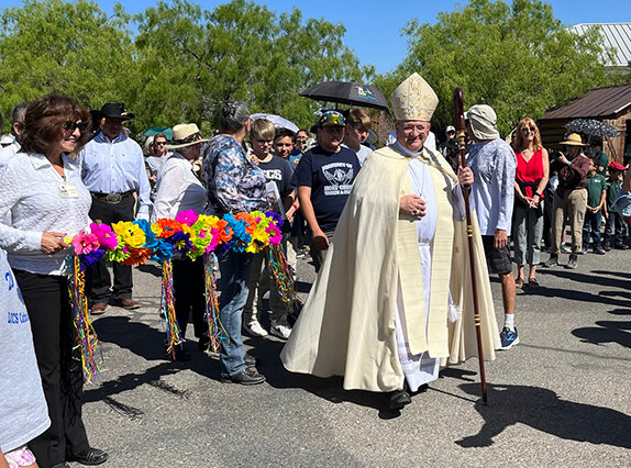 Bishop Peter Baldacchino, the third bishop of the Diocese of Las Cruces, leads the procession around the grounds at the New Mexico Farm & Ranch Heritage Museum as he blesses the animals and the fields.