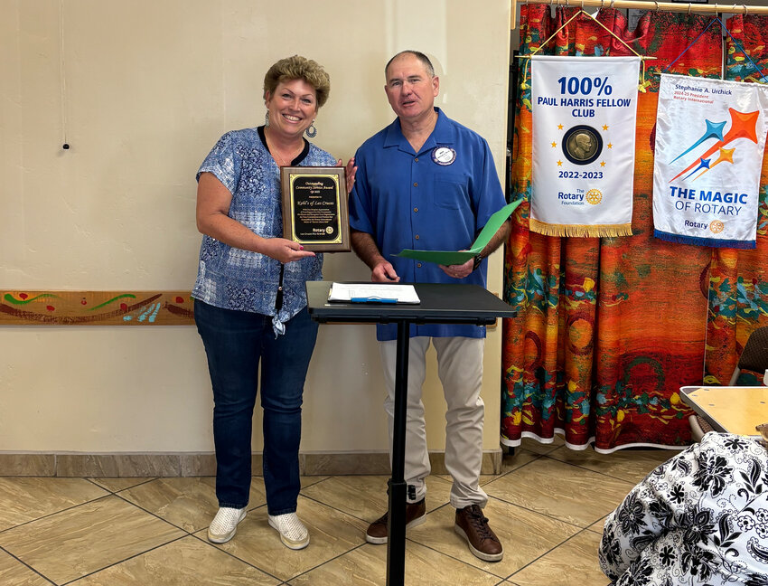 : Didi Ramando, manager at Kohl's Las Cruces and Mike Binns, a member of Las Cruces Rio Grande Rotary Club, pose for photos after Binns gives Ramando an award from the Rotary Club.