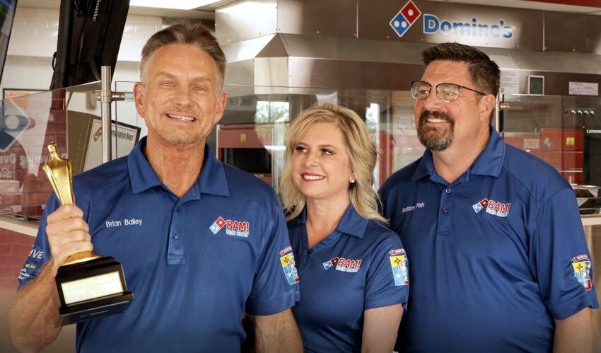 Brian Bailey, his wife, Michelle Bailey, and Anthony Fish, Domino’s store executive vice president