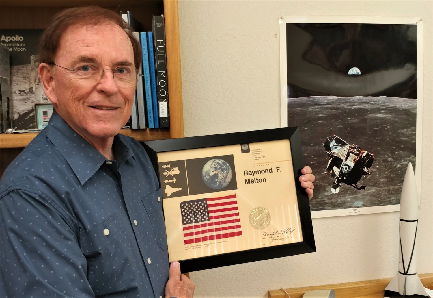 Retired NASA engineer Ray Melton with the small U.S. flag he received after it was flown to the Moon and back aboard Apollo 17, the final Apollo mission.
