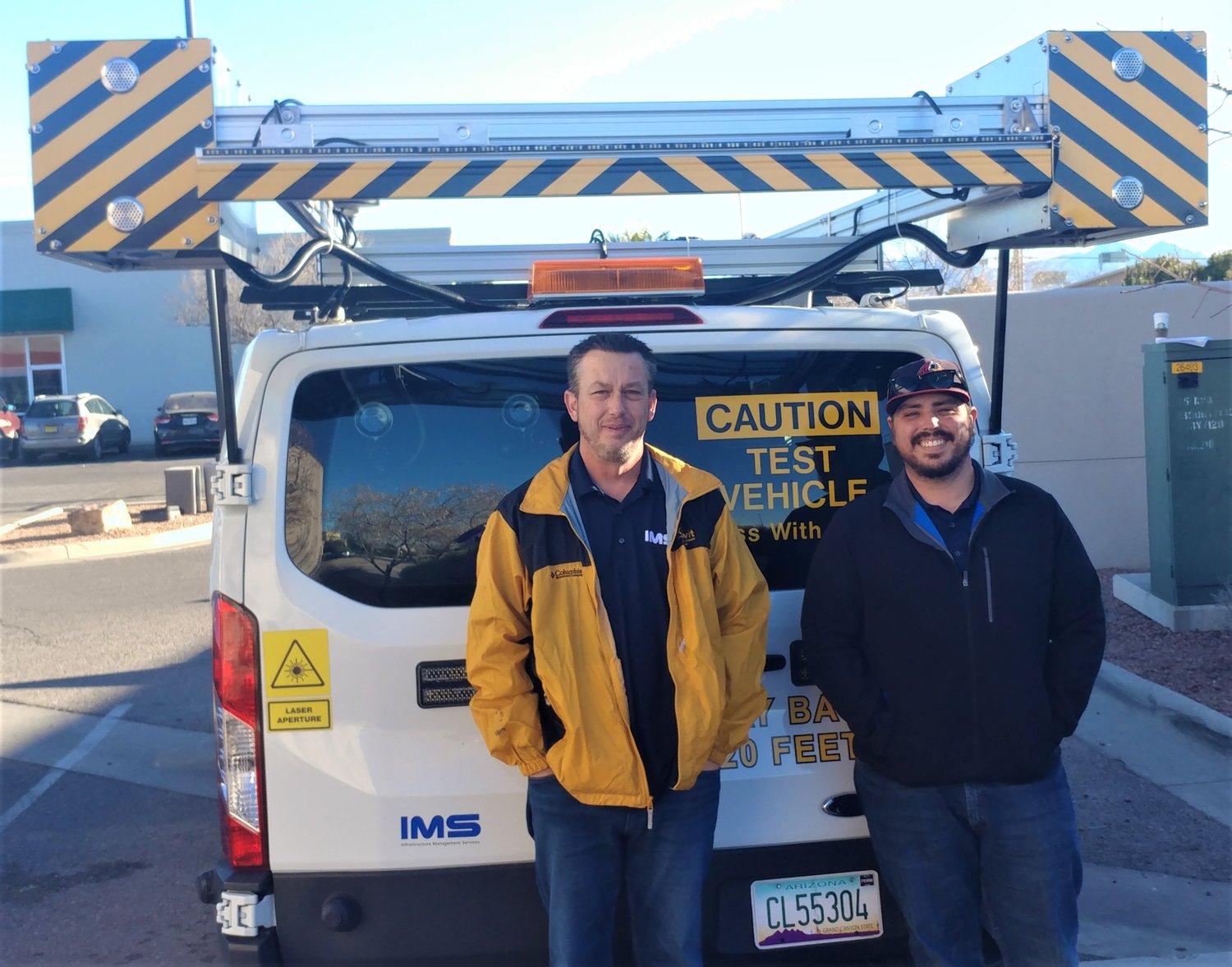 IMS crew chiefs Jason Johnson, left, and Roberto Ortiz, with their $700,000 high-tech, paving-analysis van.